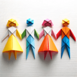 DALL·E 2023-10-24 00.28.21 – Origami representation of four vibrant human figures on a white canvas. Among them, two figures wear dresses and the other two are dressed in pants, a